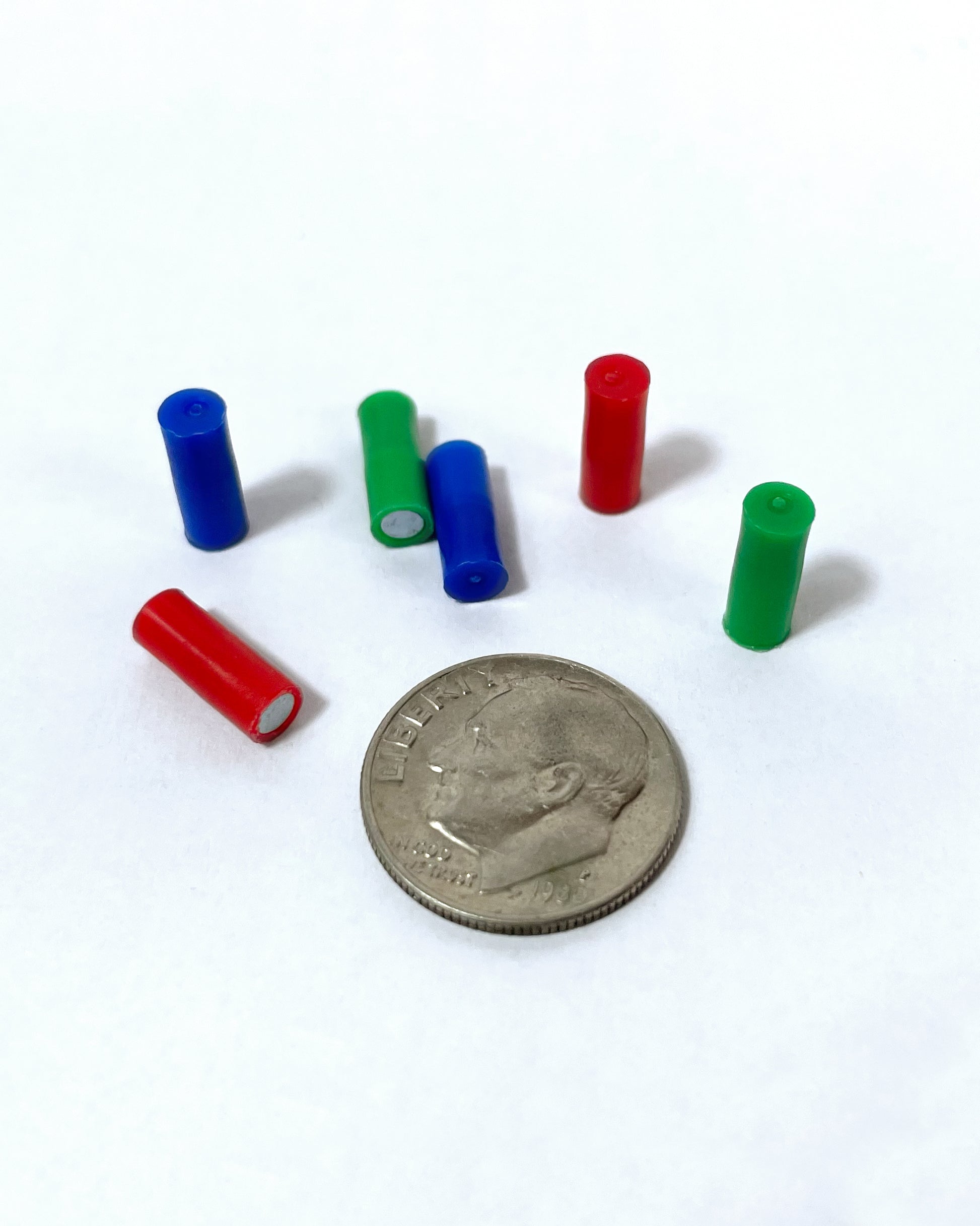 map magnets next to a dime to show size perspective