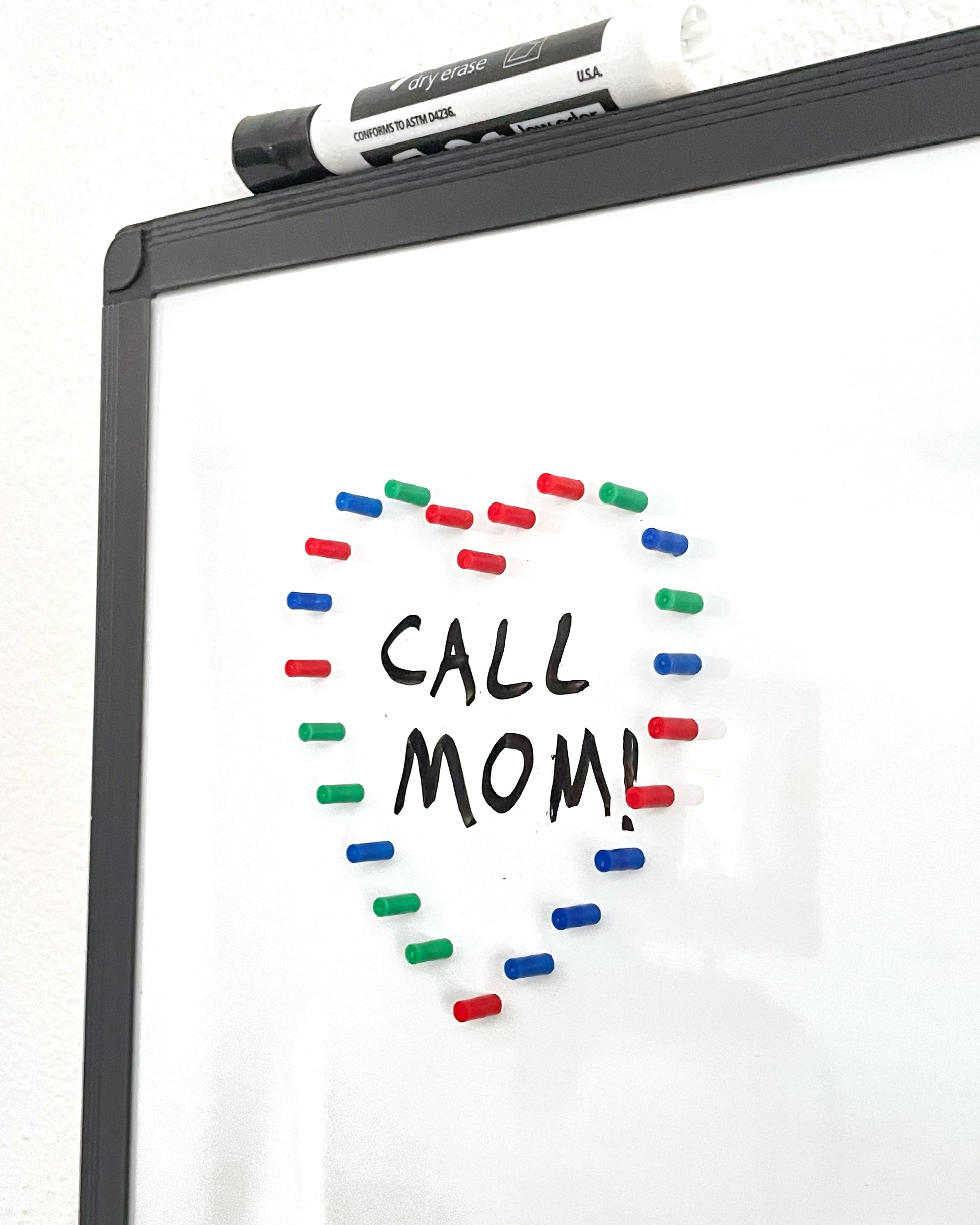 map magnets in the shape of a heart around a reminder to call mom