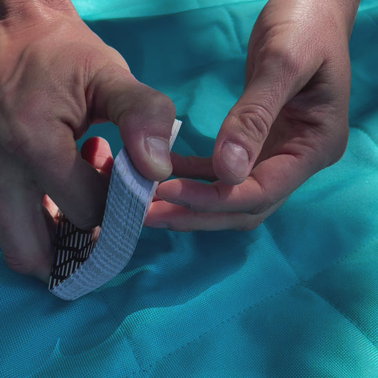 Video of the incremental playing cards being shuffled on a blue blanket outside